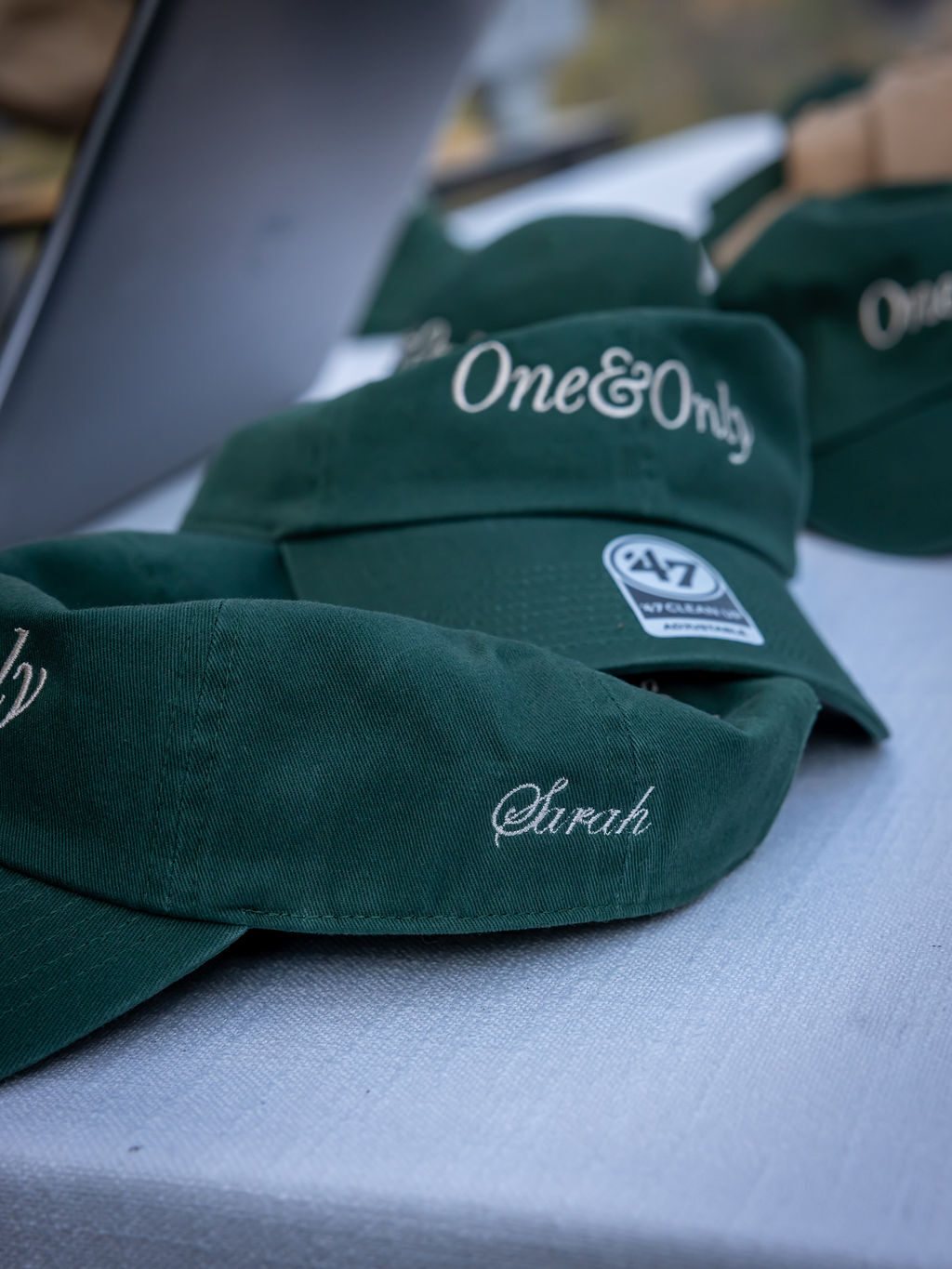 Green One&Only caps embroidered with guests’ names