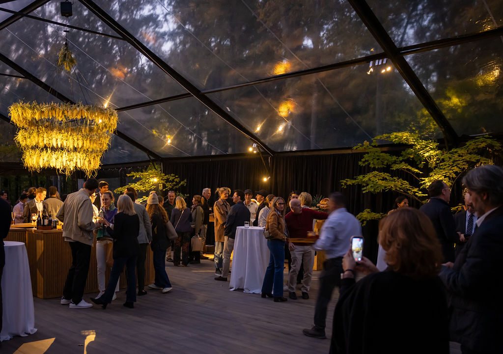 Guests filling the clear pavilion at dusk