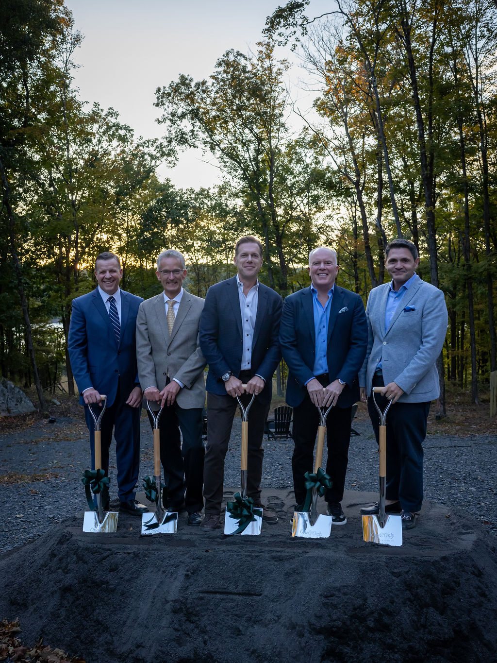 Five partners with ribboned ceremonial shovels