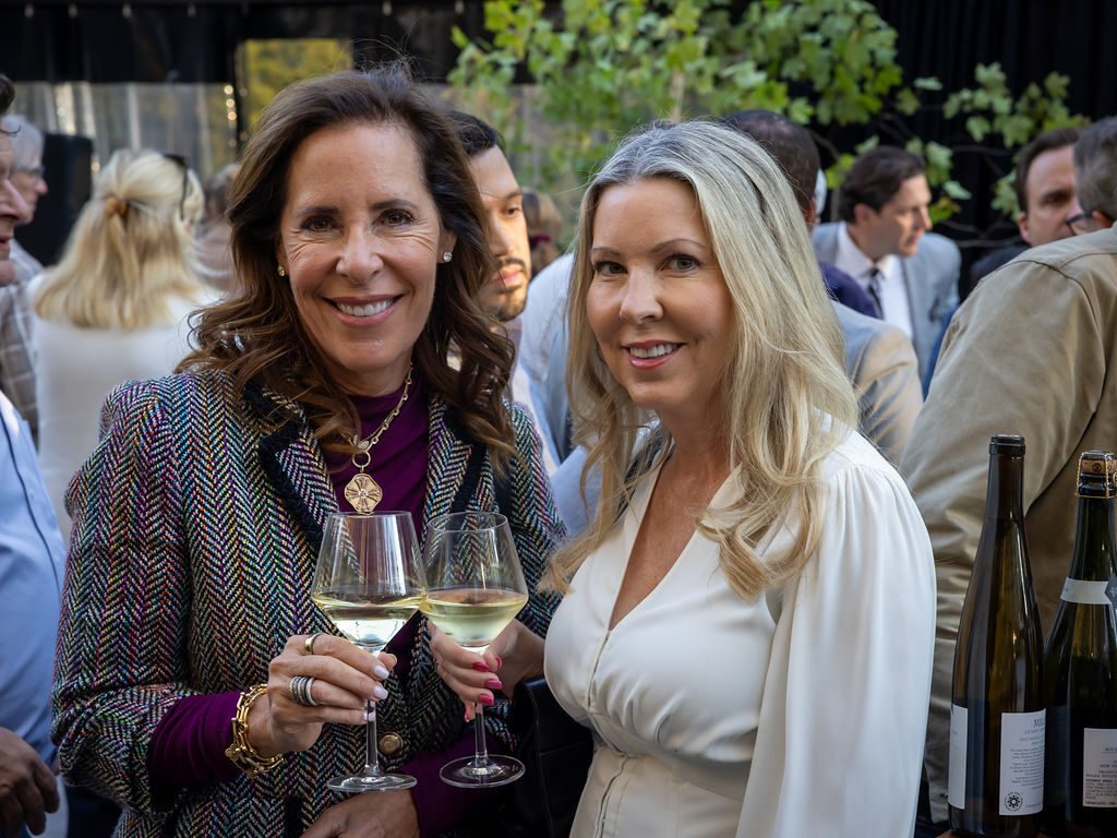 Two guests raising a glass