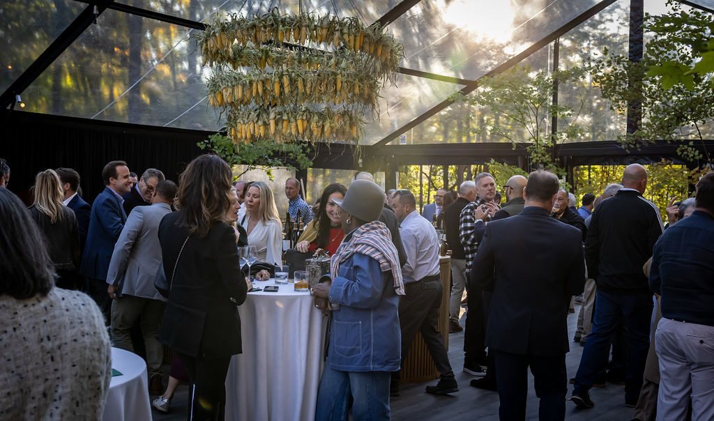 Guests beneath the corn-husk chandelier
