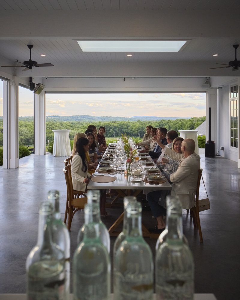 A long dining table set beneath the pavilion roof